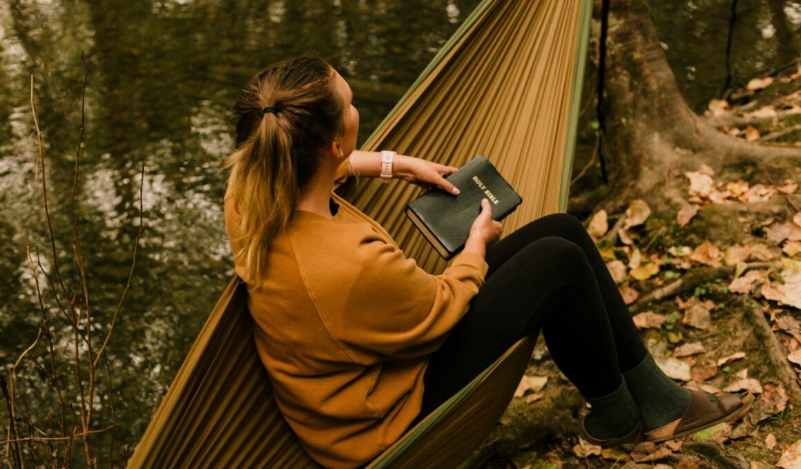 woman in brown coat and black pants sitting on brown wooden bench