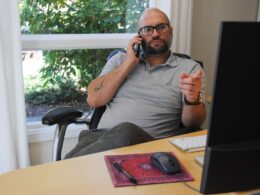 Man talking on the phone during marketing meeting.