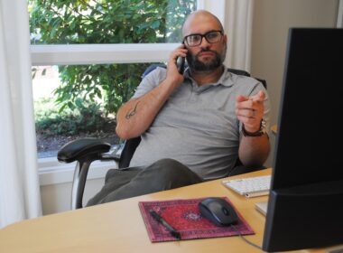 Man talking on the phone during marketing meeting.