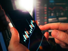 Cryptocurrency trading analysis mobile chart growth candlesticks. Close-up of hands analyzing bullish candlestick patterns on smartphone