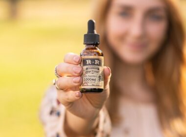 Vrouw houdt een flesje CBD-olie vast
